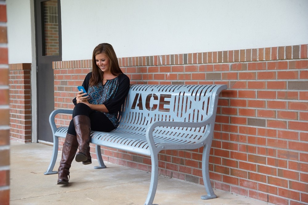 Courtney M sitting on bench